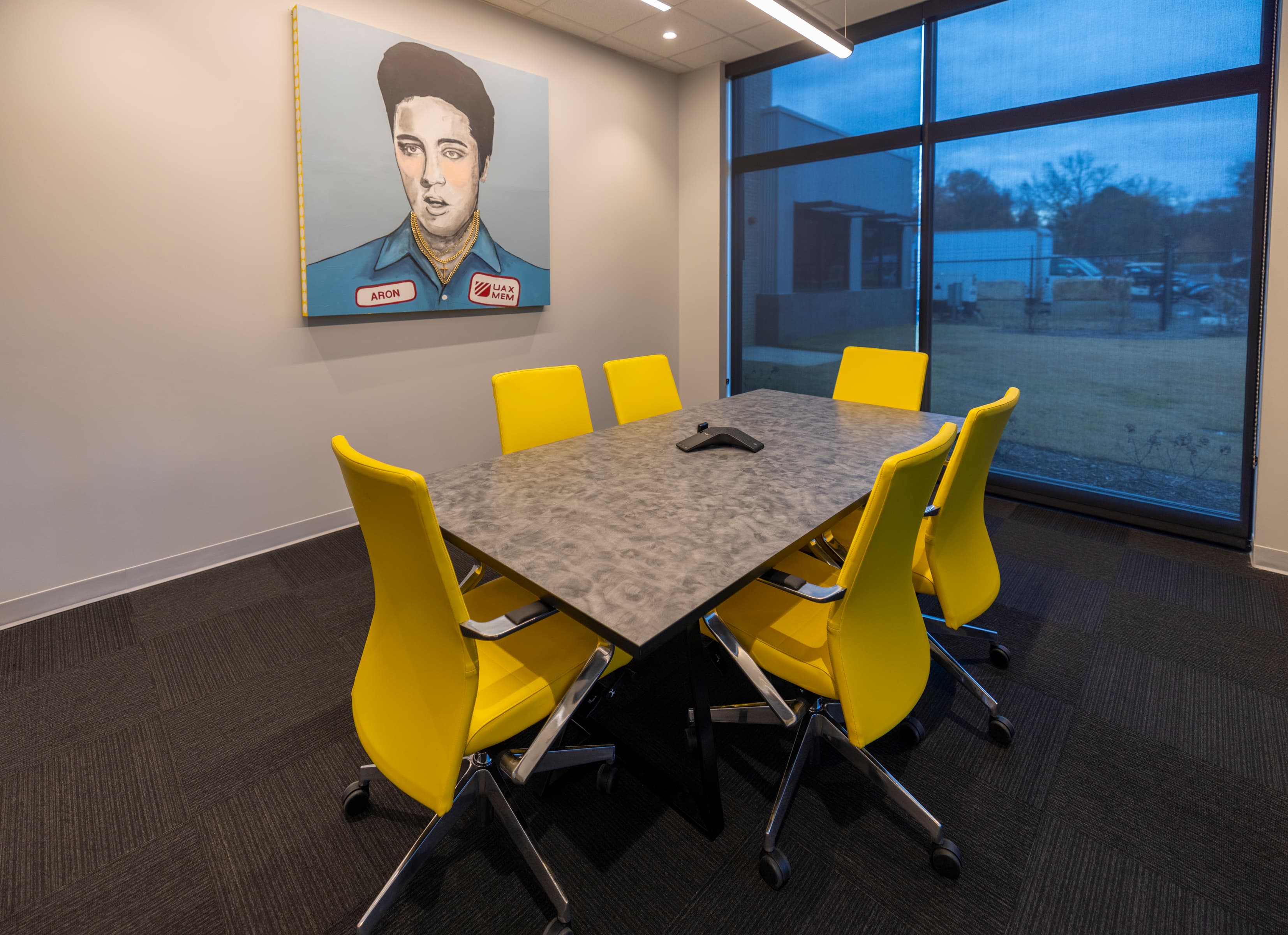 UAX conference room, Elvis 'Aron' pop-art portrait and yellow chairs